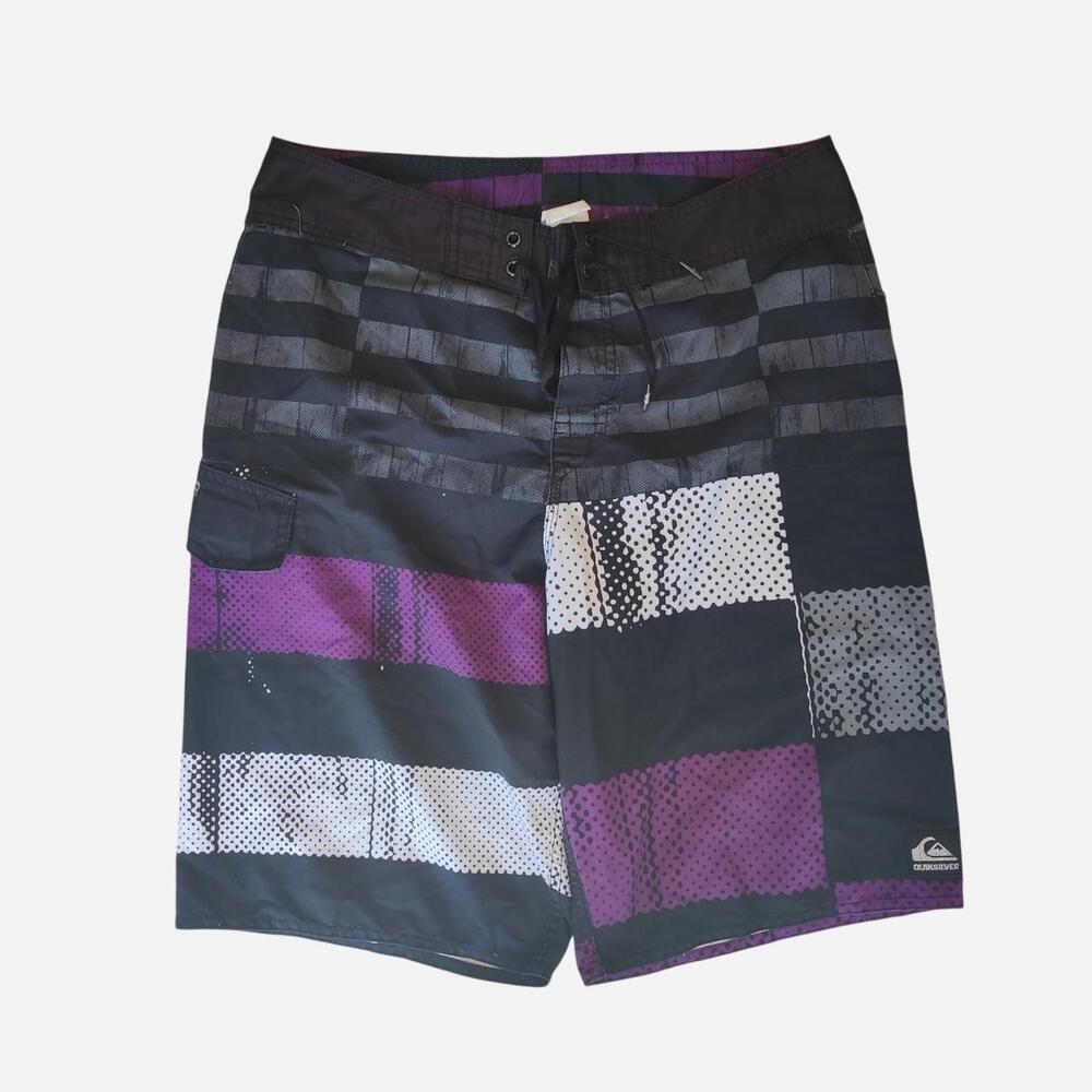 Y2K Quiksilver board shorts with horizontal stripes in black, purple, and white